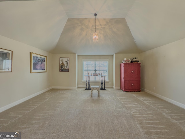 additional living space featuring baseboards, vaulted ceiling, and carpet