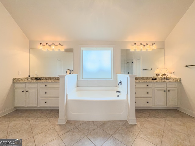 full bathroom with baseboards, a garden tub, tile patterned floors, and two vanities