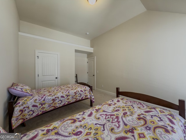 carpeted bedroom with baseboards and lofted ceiling