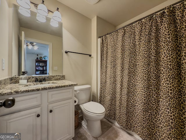 bathroom with toilet, tile patterned flooring, and vanity