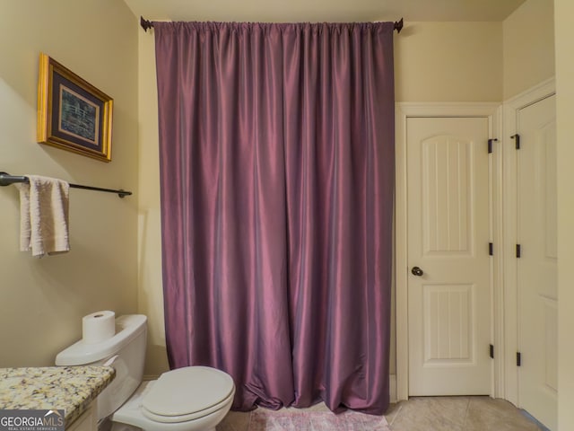 bathroom featuring tile patterned floors, vanity, and toilet