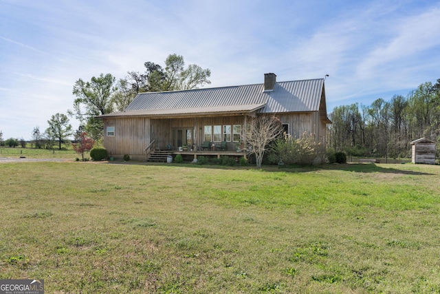 1725 Watermelon Rd, Tennille, GA 31089 - exterior space featuring a chimney, a front yard, and metal roof
