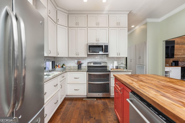 1725 Watermelon Rd, Tennille, GA 31089 - kitchen featuring decorative backsplash, crown molding, wood counters, appliances with stainless steel finishes, and dark wood-style floors