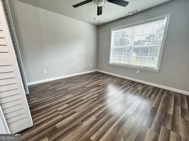 710 Bluebird Dr SE, Conyers, GA 30094 - spare room with a ceiling fan, baseboards, visible vents, and dark wood-style floors