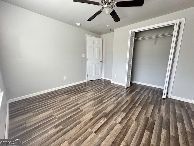 710 Bluebird Dr SE, Conyers, GA 30094 - unfurnished bedroom with baseboards, a ceiling fan, dark wood finished floors, and a closet