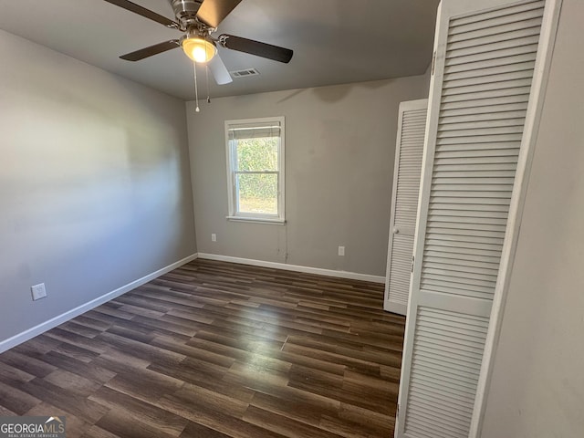710 Bluebird Dr SE, Conyers, GA 30094 - unfurnished bedroom with a ceiling fan, dark wood-style flooring, visible vents, baseboards, and a closet