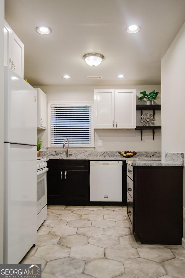 710 Bluebird Dr SE, Conyers, GA 30094 - kitchen featuring visible vents, open shelves, light stone counters, white appliances, and white cabinetry