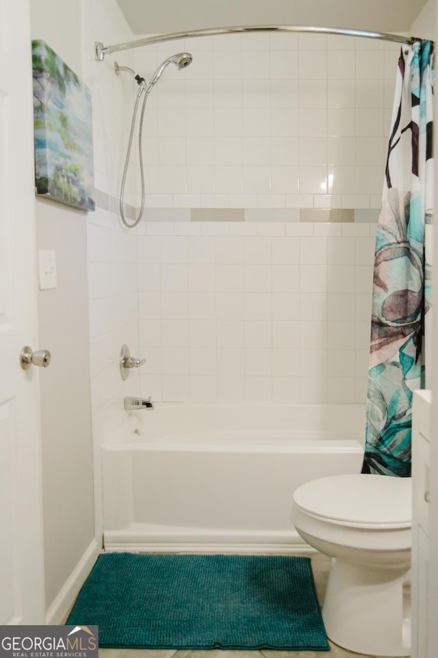 710 Bluebird Dr SE, Conyers, GA 30094 - bathroom featuring shower / bath combination with curtain and toilet