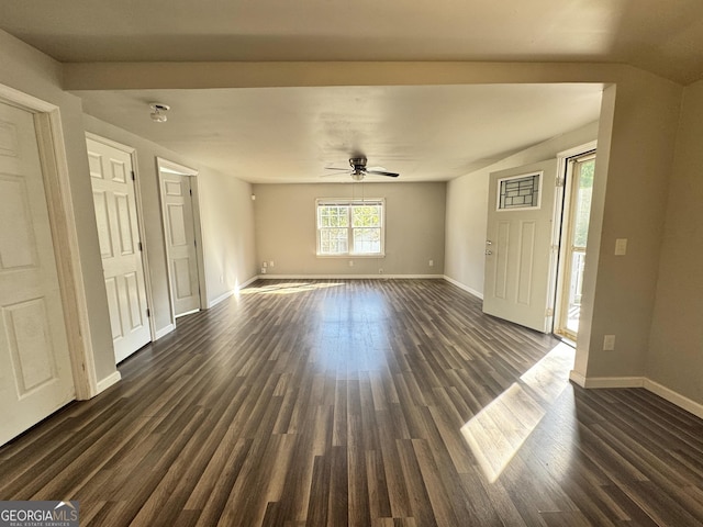 710 Bluebird Dr SE, Conyers, GA 30094 - unfurnished living room with baseboards, a ceiling fan, and dark wood-type flooring