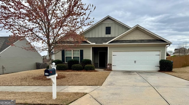 craftsman-style home with driveway, an attached garage, fence, and board and batten siding