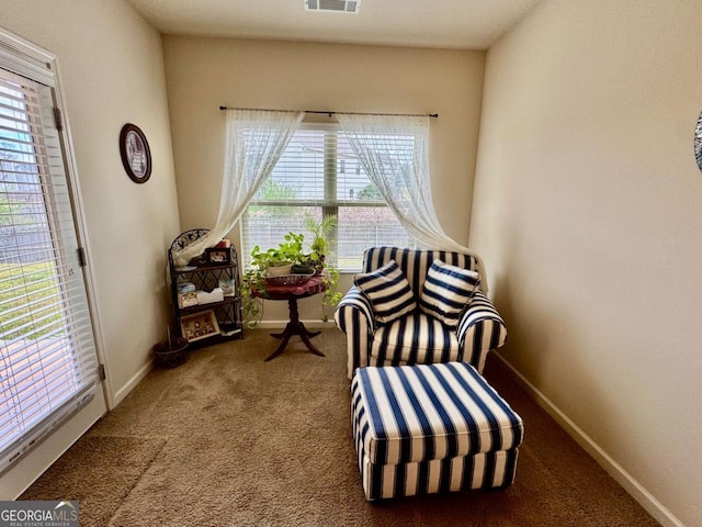 living area with baseboards, carpet flooring, and visible vents