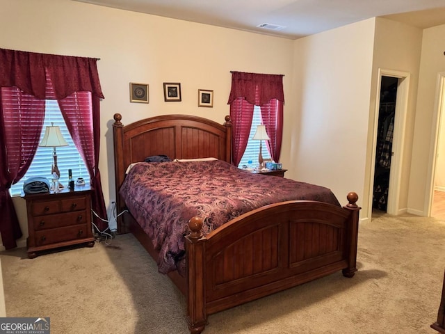 carpeted bedroom with baseboards and visible vents