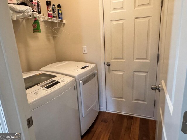 laundry area featuring independent washer and dryer, laundry area, and dark wood finished floors