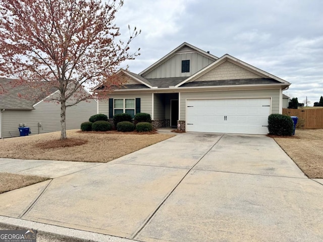 view of front of house featuring board and batten siding, concrete driveway, a garage, and fence