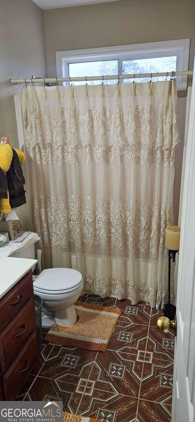 3715 Millers Pond Way, Snellville, GA 30039 - full bathroom with toilet, vanity, curtained shower, and tile patterned floors
