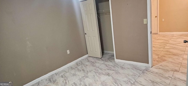 3715 Millers Pond Way, Snellville, GA 30039 - unfurnished bedroom featuring marble finish floor, a closet, and baseboards