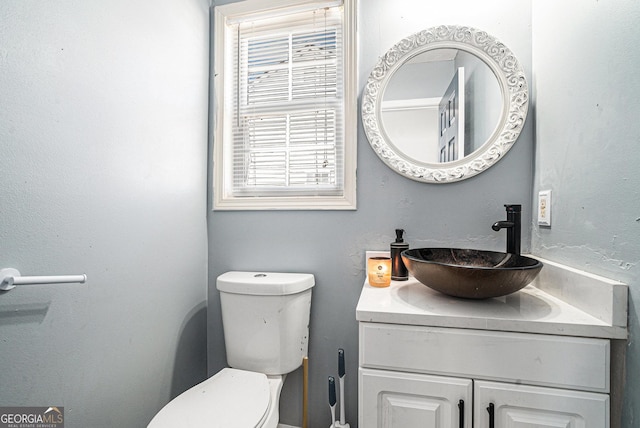bathroom with toilet and vanity