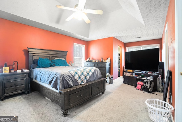 carpeted bedroom with multiple windows and a ceiling fan