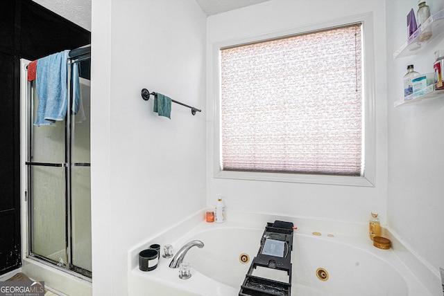 full bathroom featuring a shower stall and a jetted tub
