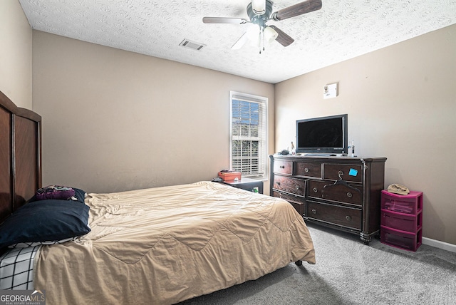 bedroom featuring baseboards, light carpet, a textured ceiling, a ceiling fan, and visible vents