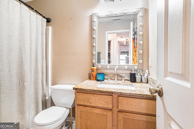 bathroom with visible vents, toilet, a shower with shower curtain, and vanity