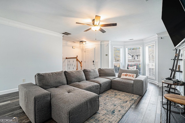 living area with crown molding, baseboards, a ceiling fan, and visible vents