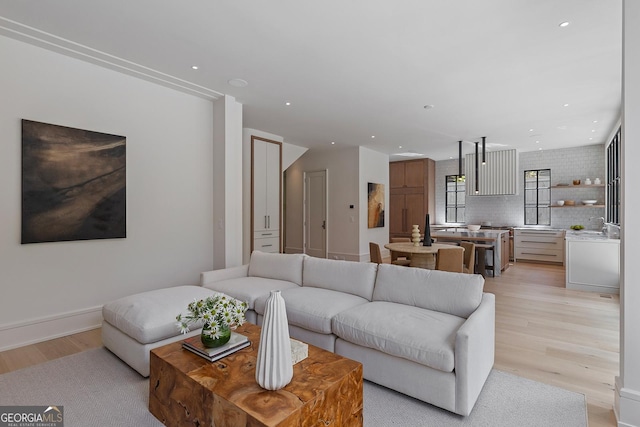 living area with recessed lighting and light wood finished floors
