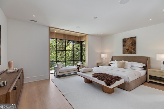 bedroom with light wood-type flooring, baseboards, visible vents, and recessed lighting