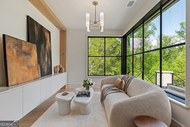 interior space featuring visible vents and an inviting chandelier