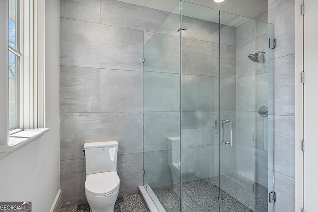 full bathroom featuring toilet and a shower stall