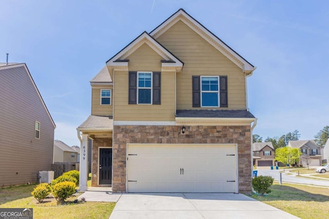 6399 Woodwell Dr, Union City, GA 30291 - craftsman-style house with stone siding, an attached garage, driveway, and roof with shingles