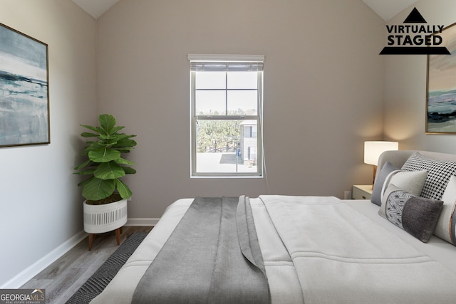 6399 Woodwell Dr, Union City, GA 30291 - bedroom featuring vaulted ceiling and wood finished floors