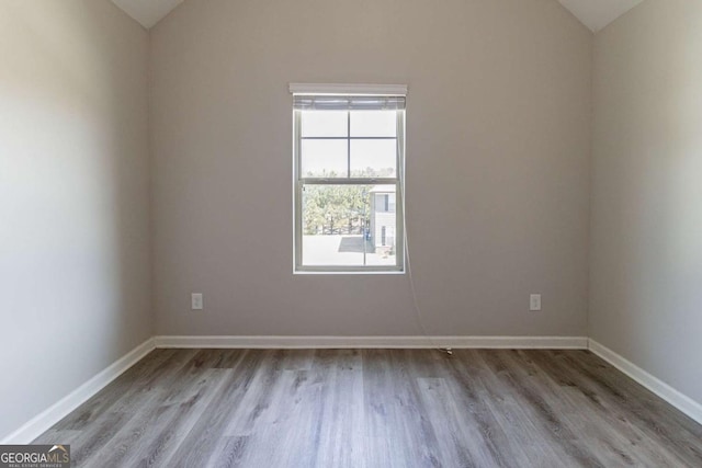 6399 Woodwell Dr, Union City, GA 30291 - empty room with vaulted ceiling and light wood-style flooring