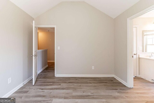6399 Woodwell Dr, Union City, GA 30291 - unfurnished room featuring vaulted ceiling and wood finished floors