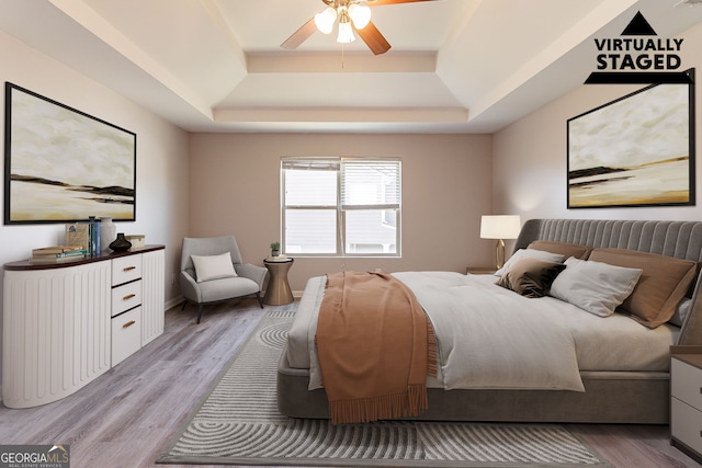 6399 Woodwell Dr, Union City, GA 30291 - bedroom featuring a raised ceiling, light wood-style flooring, and ceiling fan