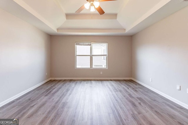 6399 Woodwell Dr, Union City, GA 30291 - spare room featuring a tray ceiling, ceiling fan, and wood finished floors
