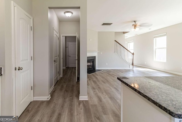 6399 Woodwell Dr, Union City, GA 30291 - unfurnished living room with stairway, a ceiling fan, light wood-style floors, and a fireplace with flush hearth