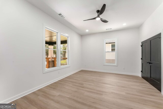 1569 Montreat Ave SW, Atlanta, GA 30311 - unfurnished bedroom with light wood finished floors, baseboards, multiple windows, and visible vents