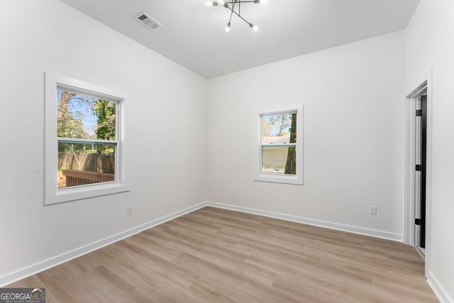 1569 Montreat Ave SW, Atlanta, GA 30311 - spare room featuring light wood-style flooring, a healthy amount of sunlight, and visible vents