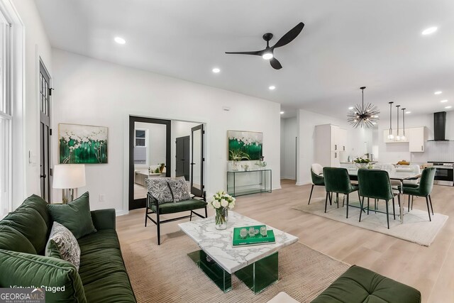 1569 Montreat Ave SW, Atlanta, GA 30311 - living room with light wood-type flooring, ceiling fan with notable chandelier, baseboards, and recessed lighting