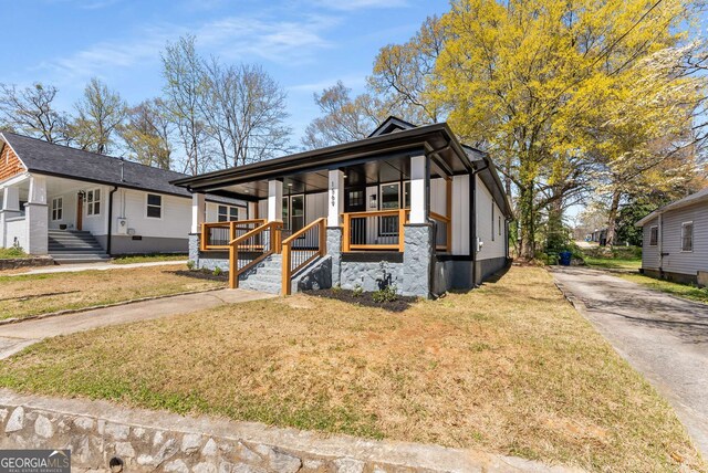 1569 Montreat Ave SW, Atlanta, GA 30311 - view of front of house featuring covered porch, a front yard, and driveway