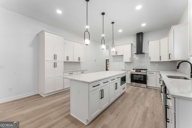 1569 Montreat Ave SW, Atlanta, GA 30311 - kitchen featuring wall chimney exhaust hood, light stone countertops, a sink, stainless steel appliances, and decorative backsplash