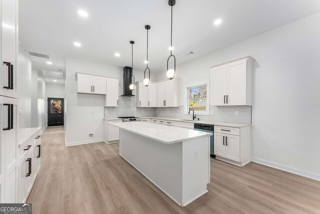 1569 Montreat Ave SW, Atlanta, GA 30311 - kitchen featuring visible vents, dishwasher, a sink, wall chimney range hood, and light wood-style floors