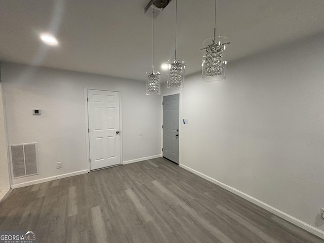 3685 Rice Mill Rd, Macon, GA 31206 - unfurnished dining area with wood finished floors, baseboards, and a chandelier