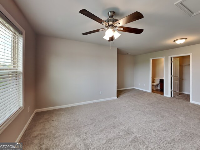3741 Upland Dr, Mcdonough, GA 30253 - unfurnished bedroom featuring carpet, baseboards, a walk in closet, a ceiling fan, and connected bathroom