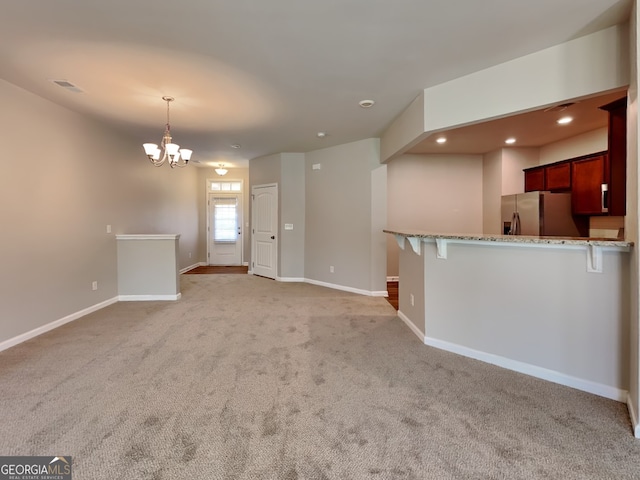 3741 Upland Dr, Mcdonough, GA 30253 - unfurnished living room featuring light carpet, a chandelier, baseboards, and recessed lighting