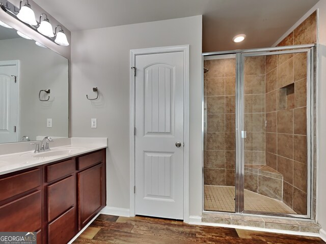 3741 Upland Dr, Mcdonough, GA 30253 - bathroom with a stall shower, wood finished floors, vanity, baseboards, and recessed lighting