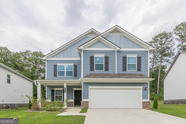 9061 Jim Purcell Dr, Covington, GA 30014 - craftsman-style home with board and batten siding, a porch, an attached garage, a front yard, and driveway