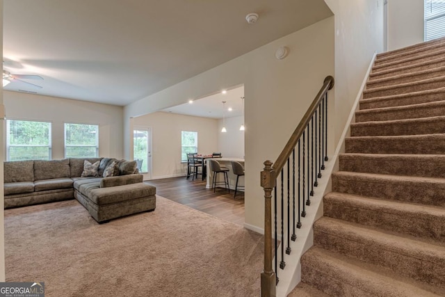 9061 Jim Purcell Dr, Covington, GA 30014 - living room featuring stairway, healthy amount of natural light, carpet floors, and wood finished floors