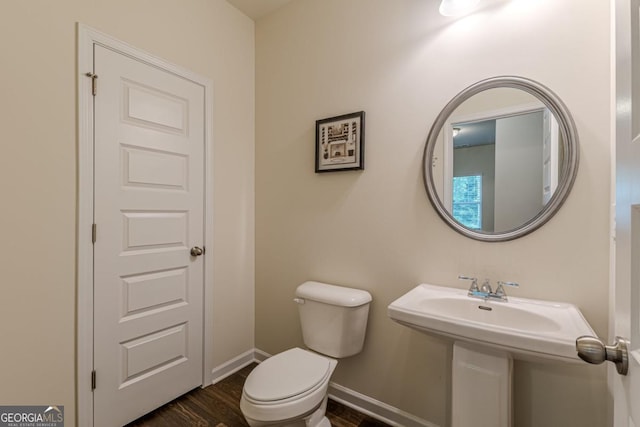 9061 Jim Purcell Dr, Covington, GA 30014 - bathroom with toilet and wood finished floors